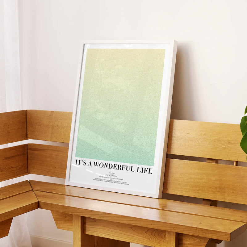 A framed It's a Wonderful Life movie script poster displayed on a sideboard in a contemporary space.