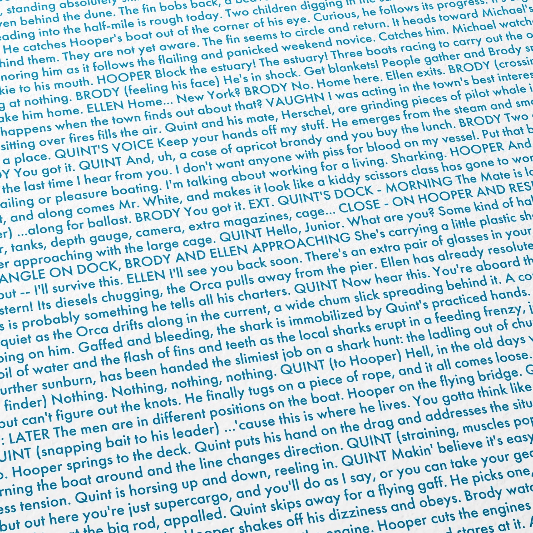 Close-up detail of the Jaws movie script poster showing dense typographic text.