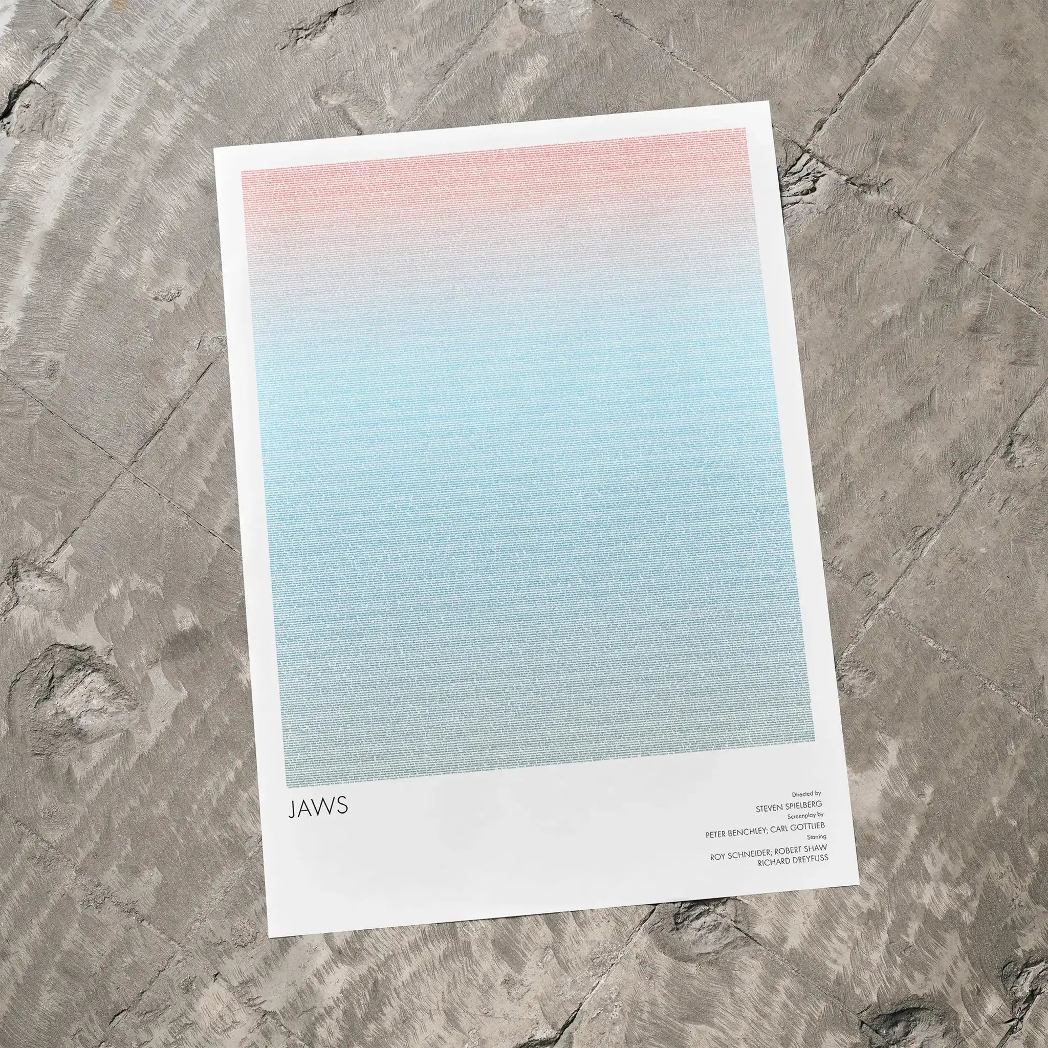 A Jaws movie script poster laid flat on a textured floor surface.