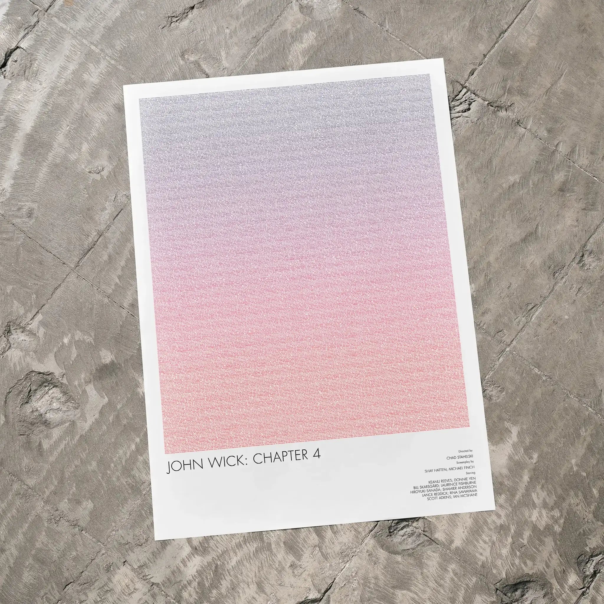 A John Wick: Chapter 4 movie script poster laid flat on a textured floor surface.