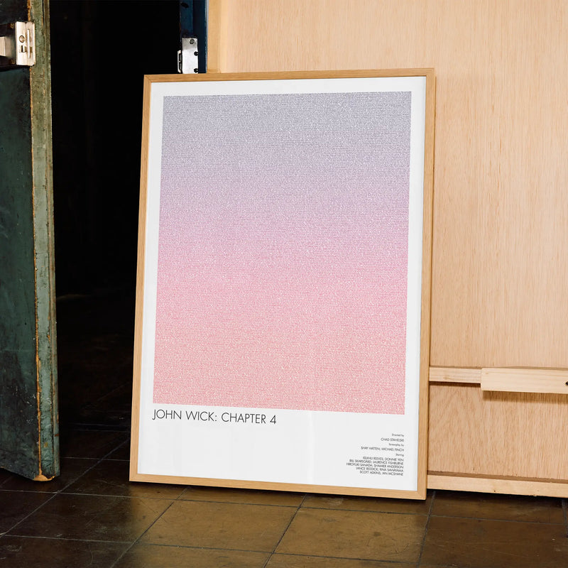 A framed John Wick: Chapter 4 movie script poster displayed in a contemporary interior setting.