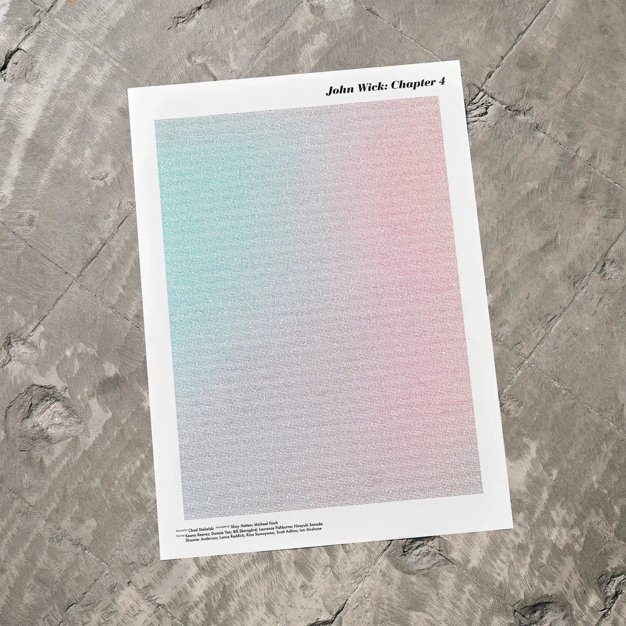 A John Wick: Chapter 4 movie script poster laid flat on a textured floor surface.