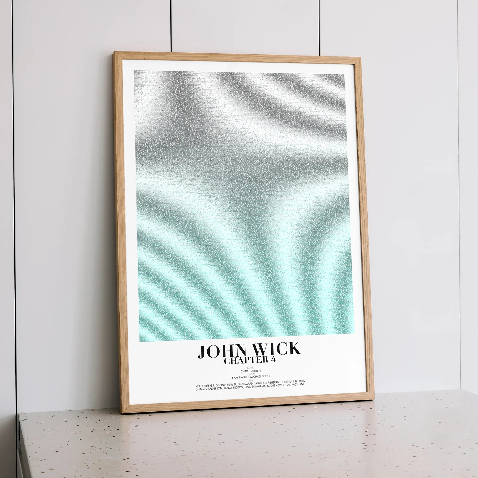 A framed John Wick: Chapter 4 movie script poster styled within a calm interior space.