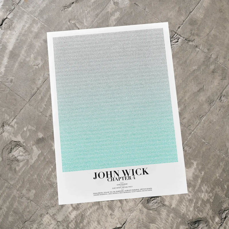 A John Wick: Chapter 4 movie script poster laid flat on a textured floor surface.