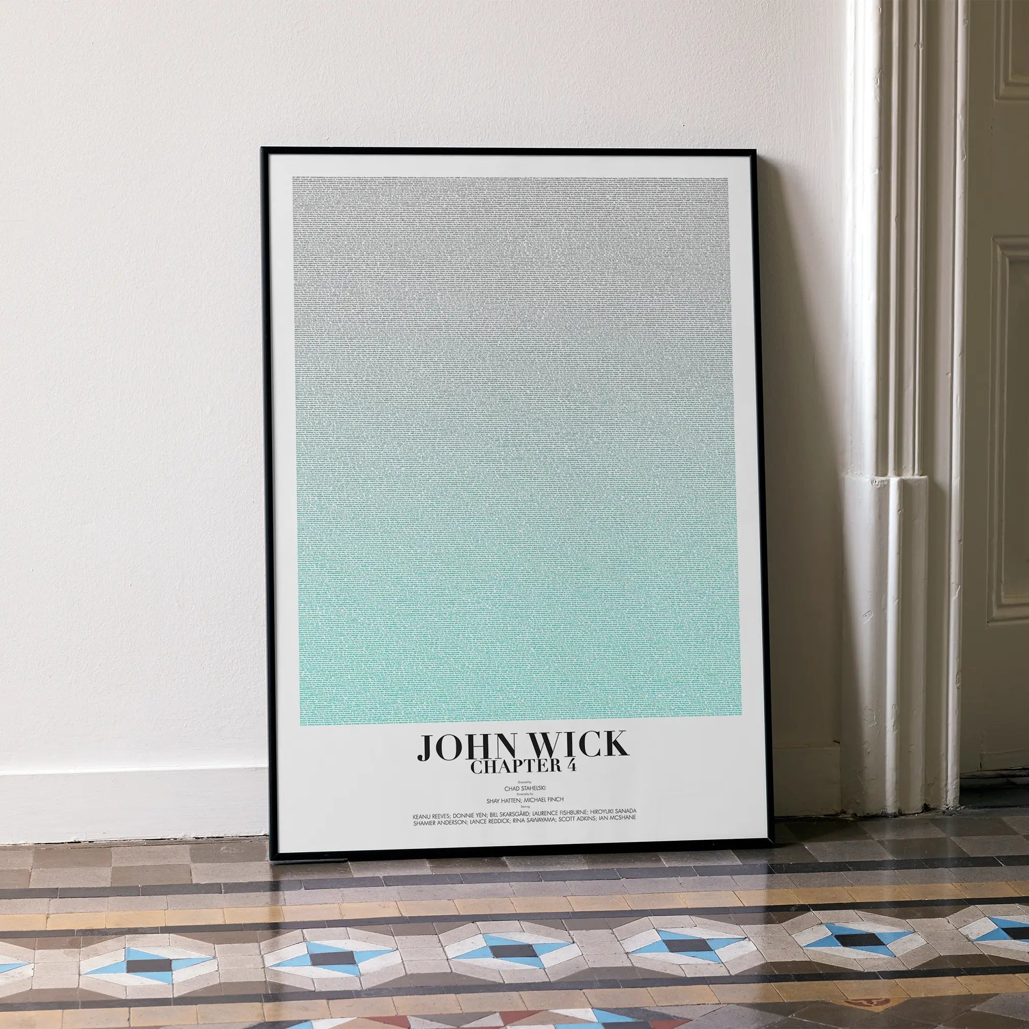 A framed John Wick: Chapter 4 movie script poster leaning against a wall in a minimalist interior.