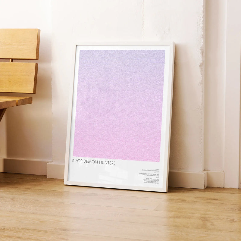 A framed K-Pop Demon Hunters movie script poster leaning against a wall in a modern interior.