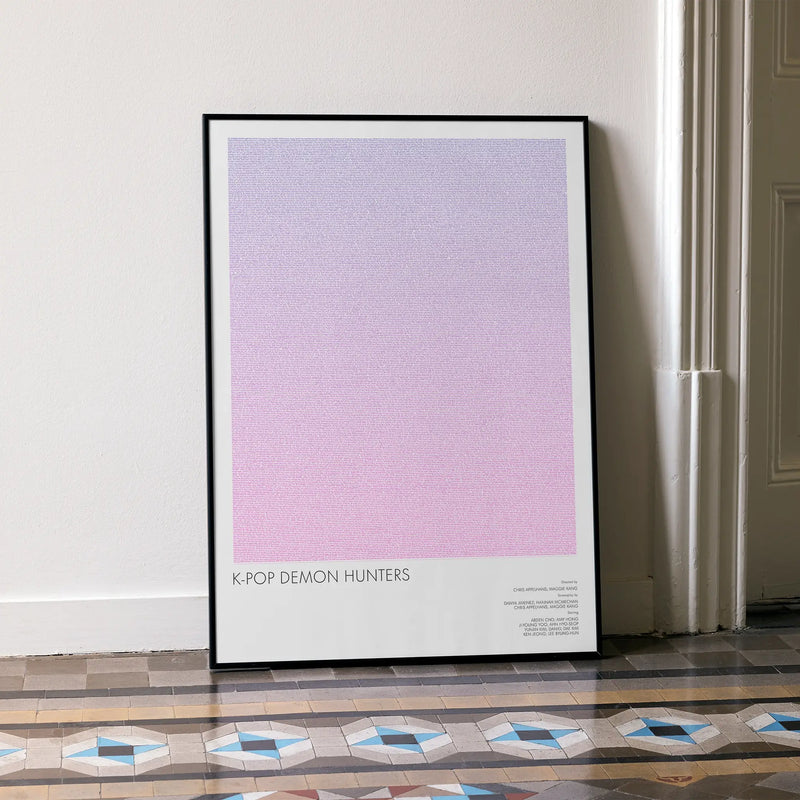 A framed K-Pop Demon Hunters movie script poster leaning against a wall in a minimalist interior.