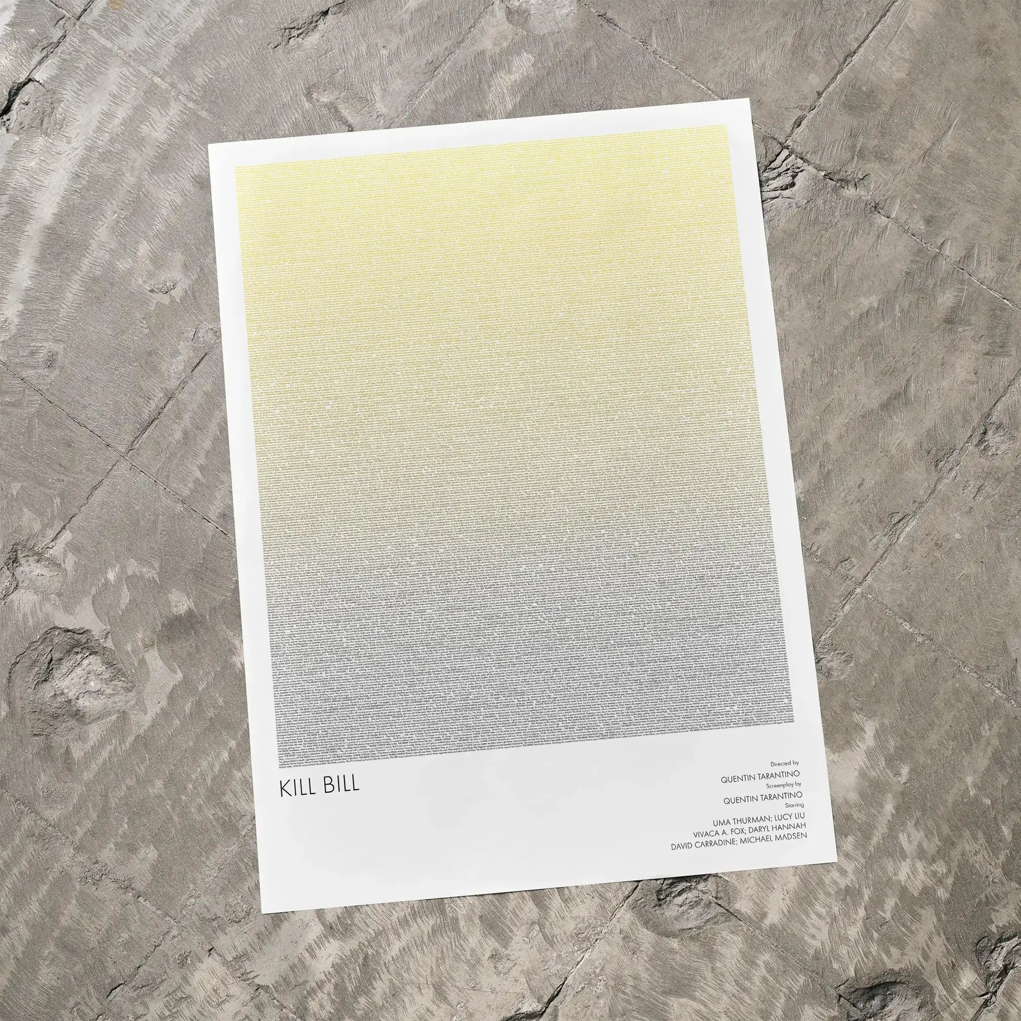 A Kill Bill movie script poster laid flat on a textured floor surface.