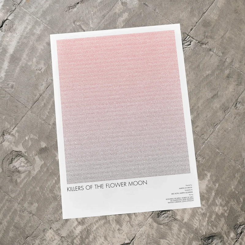 A Killers of the Flower Moon movie script poster laid flat on a textured floor surface.