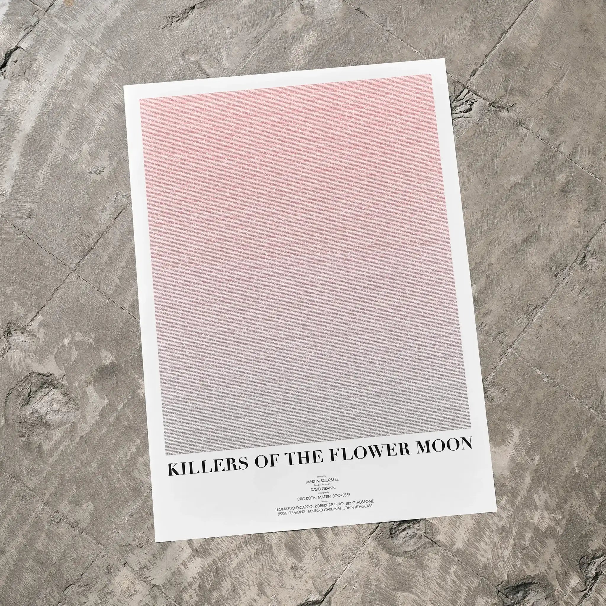 A Killers of the Flower Moon movie script poster laid flat on a textured floor surface.