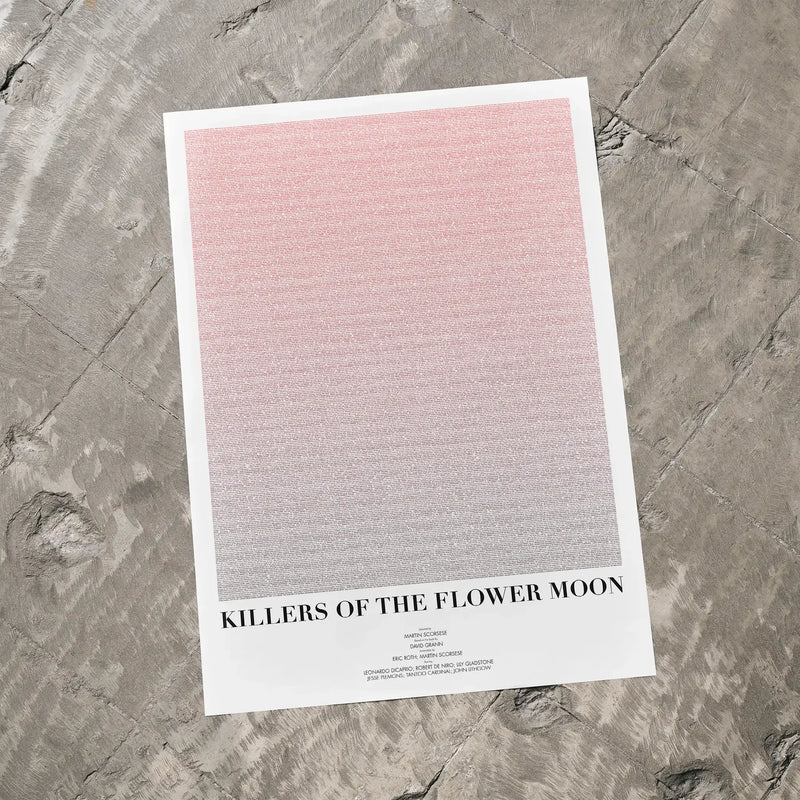 A Killers of the Flower Moon movie script poster laid flat on a textured floor surface.