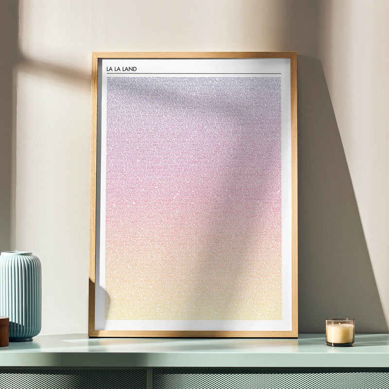 Framed La La Land movie artwork with gradient design on a table with decorative items.