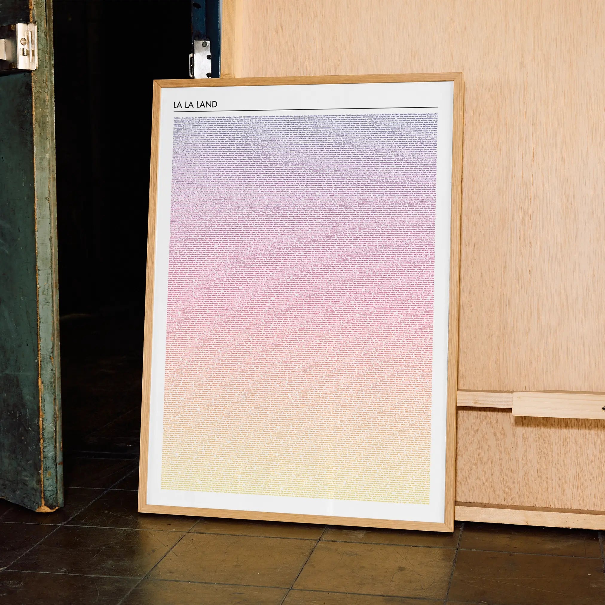 Framed La La Land poster artwork with a gradient from purple to yellow on a tiled floor.