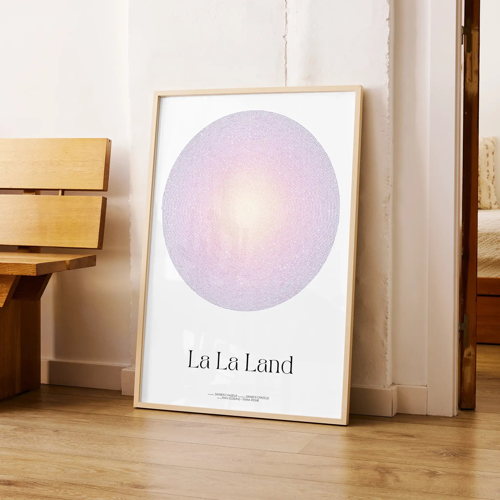 A framed La La Land movie script poster leaning against a wall in a modern interior.