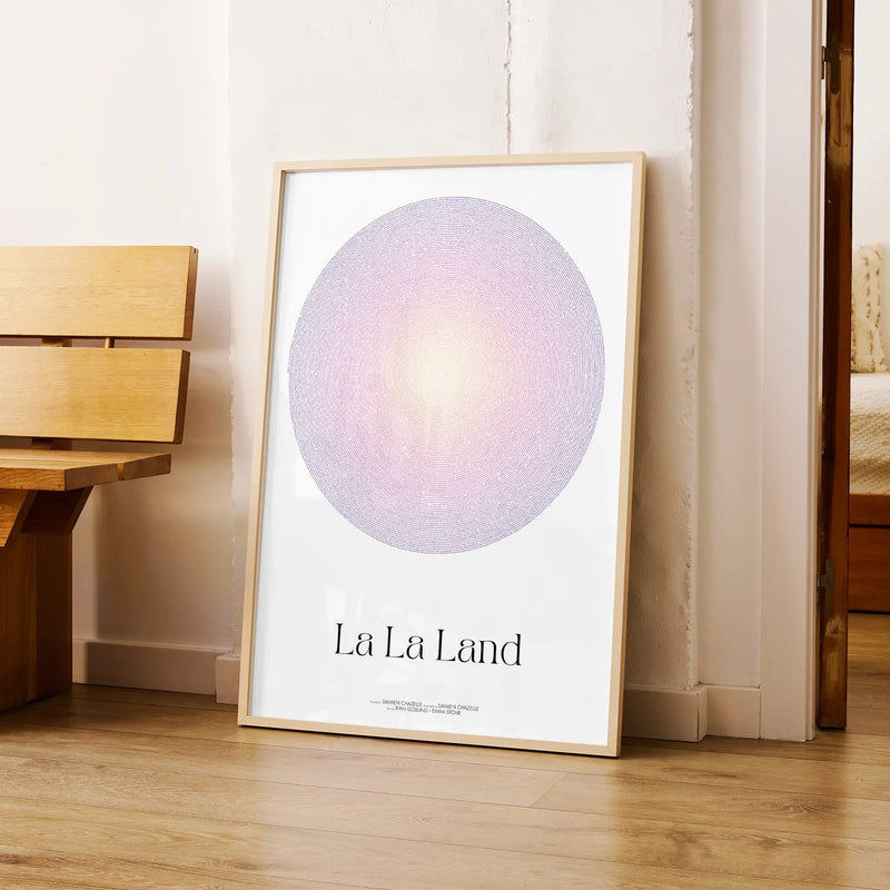 A framed La La Land movie script poster leaning against a wall in a modern interior.