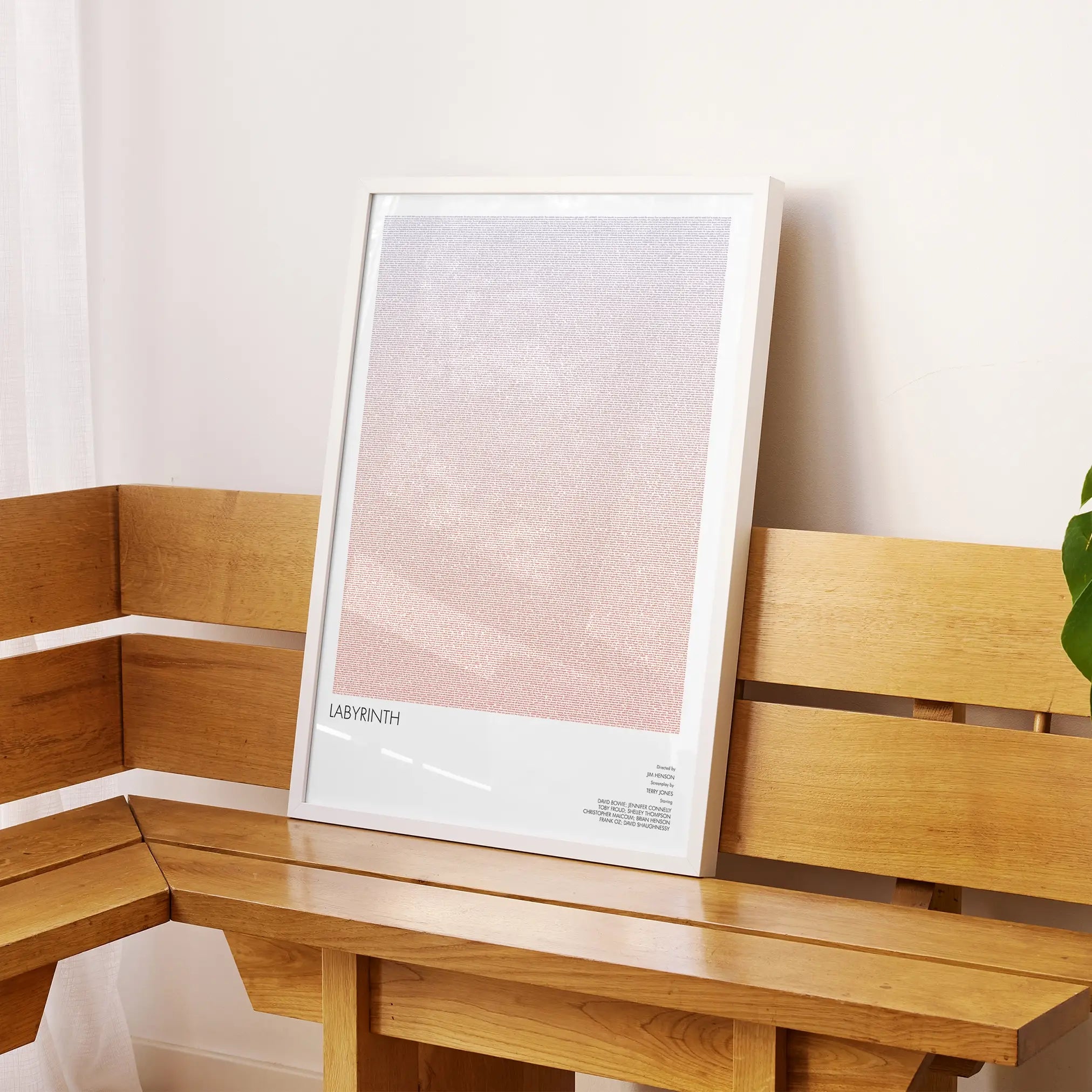 A framed Labyrinth movie script poster displayed on a sideboard in a contemporary space.