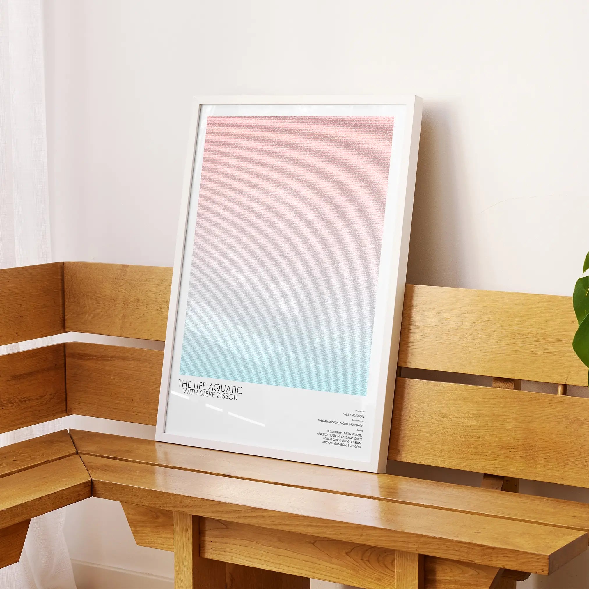 A framed The Life Aquatic with Steve Zissou movie script poster displayed on a sideboard in a contemporary space.