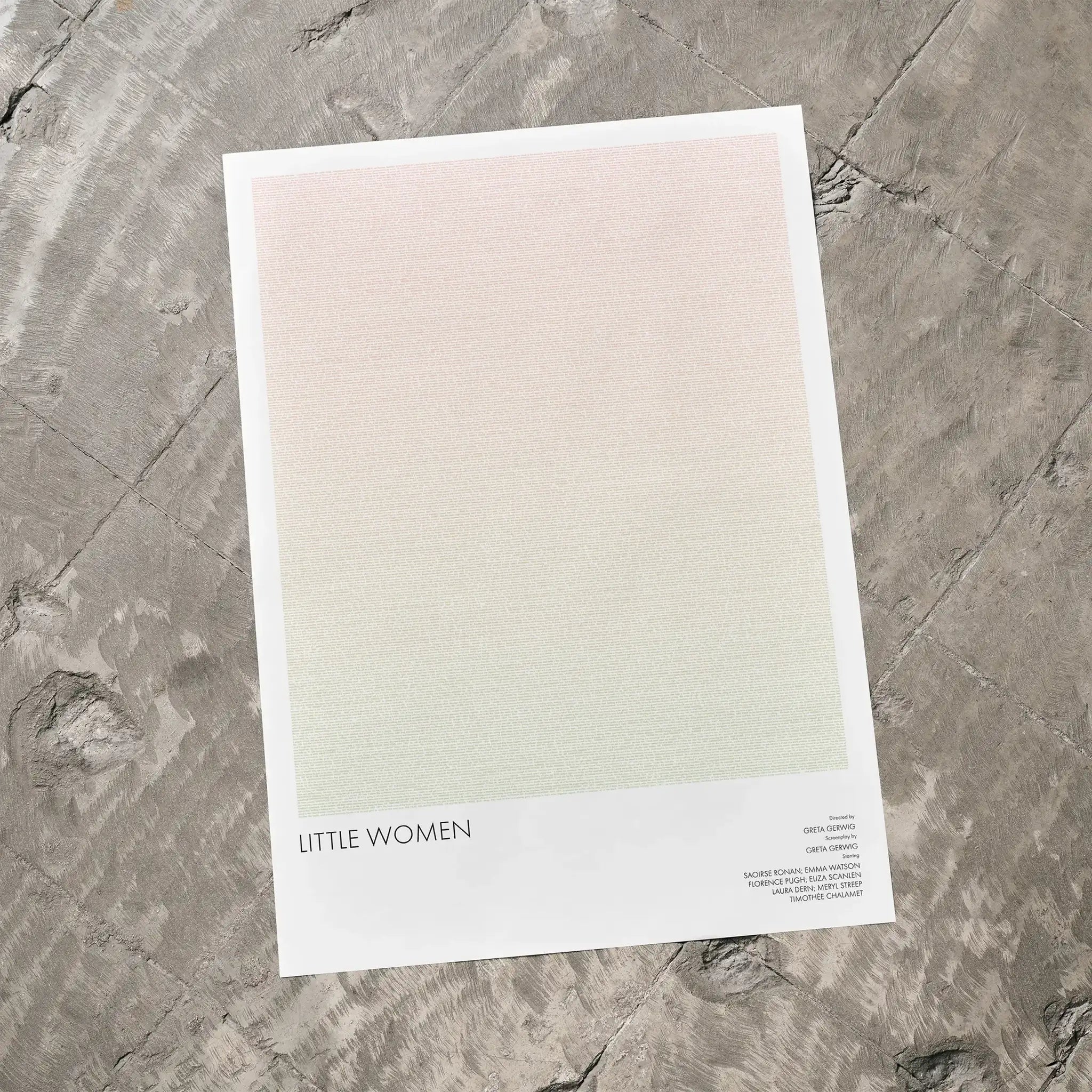 A Little Women movie script poster laid flat on a textured floor surface.