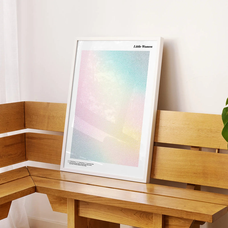 A framed Little Women movie script poster displayed on a sideboard in a contemporary space.