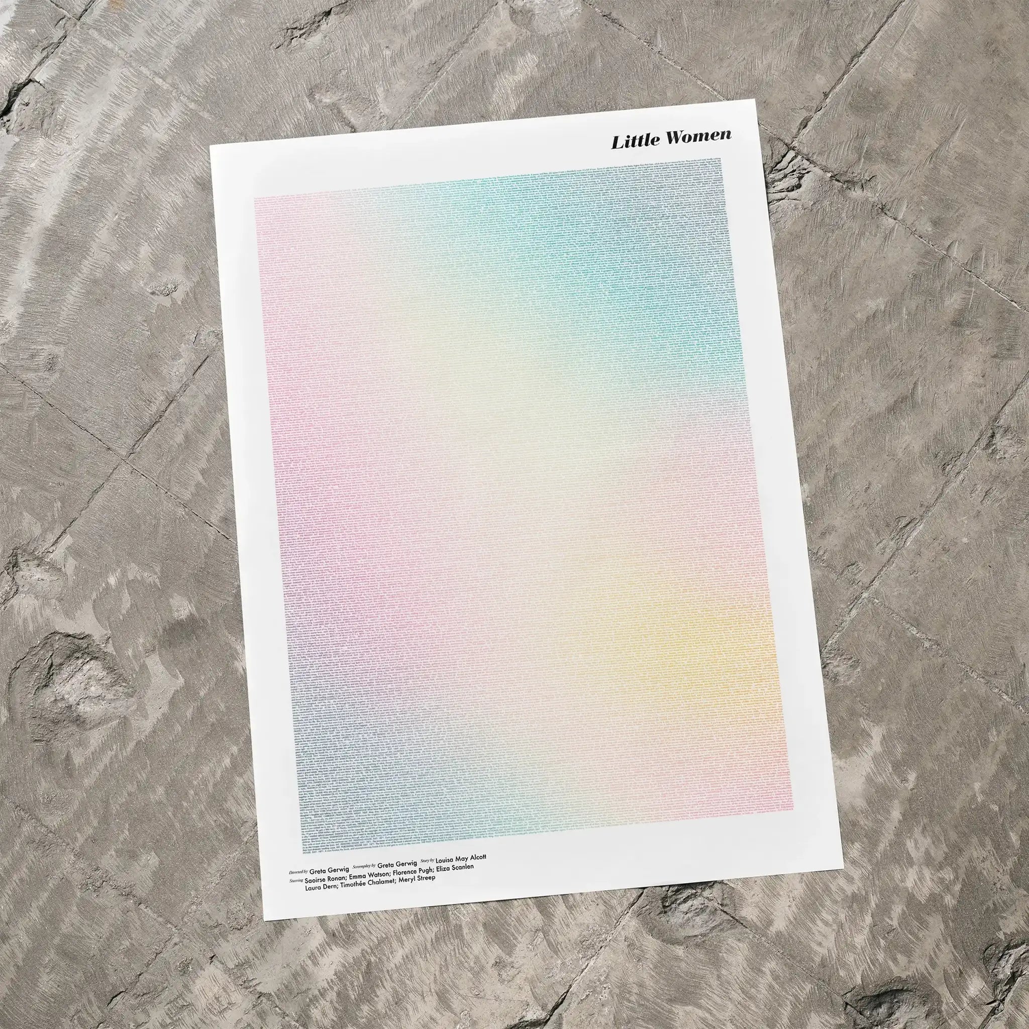 A Little Women movie script poster laid flat on a textured floor surface.