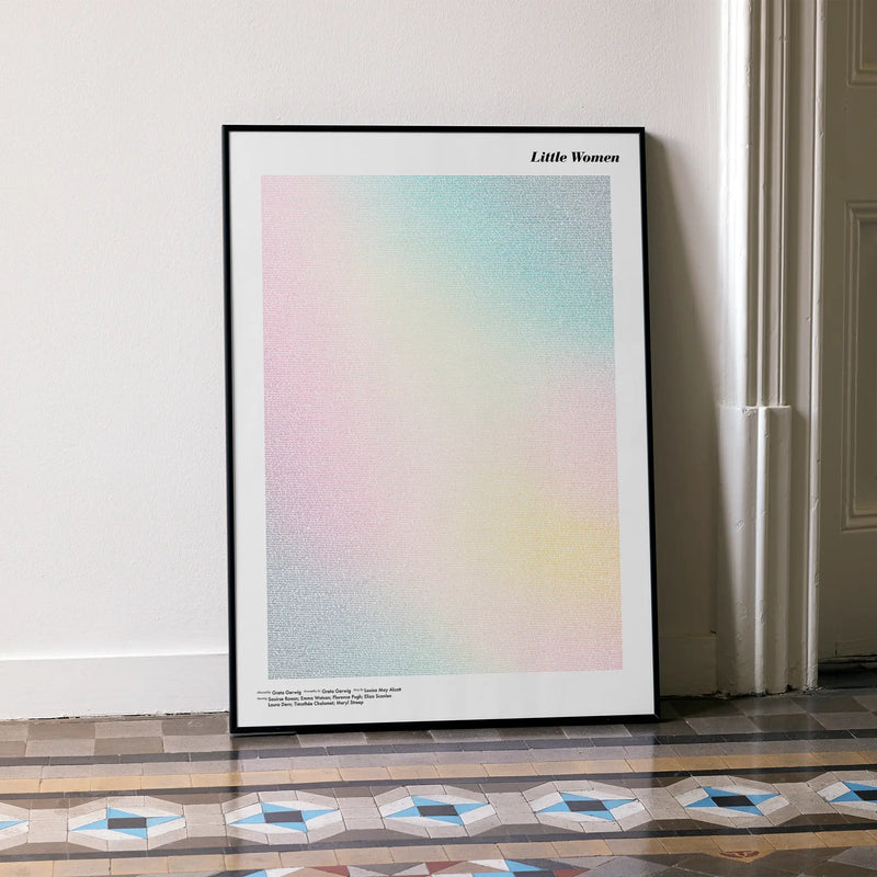 A framed Little Women movie script poster leaning against a wall in a minimalist interior.
