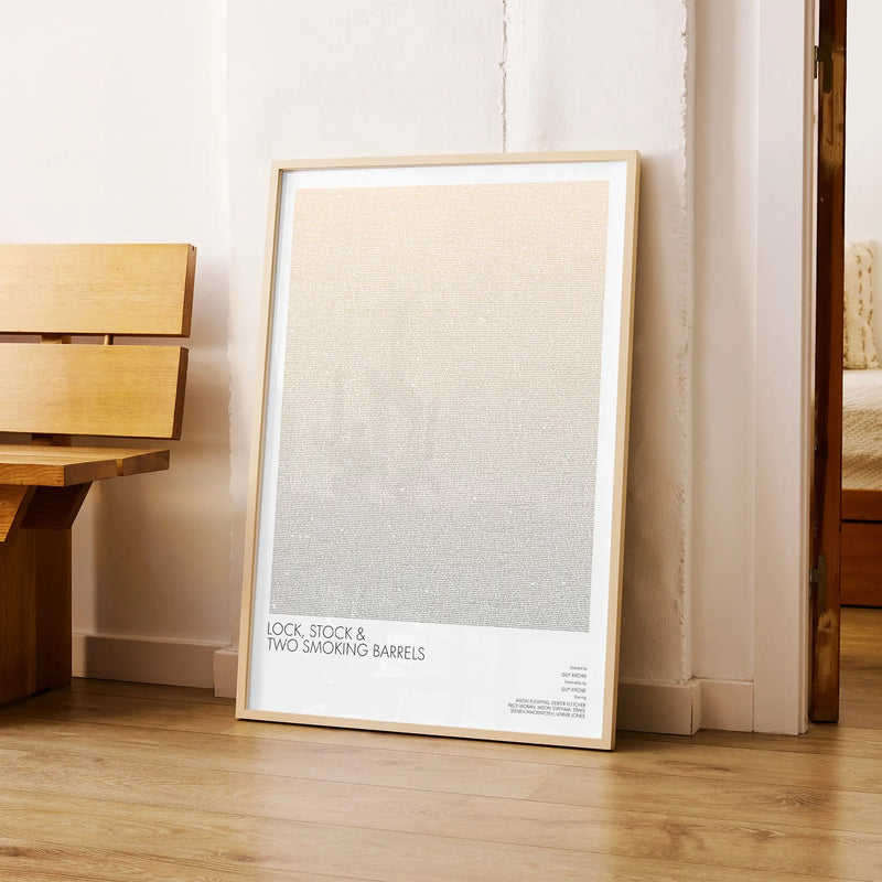 A framed Lock, Stock and Two Smoking Barrels movie script poster arranged in a minimalist interior setting.