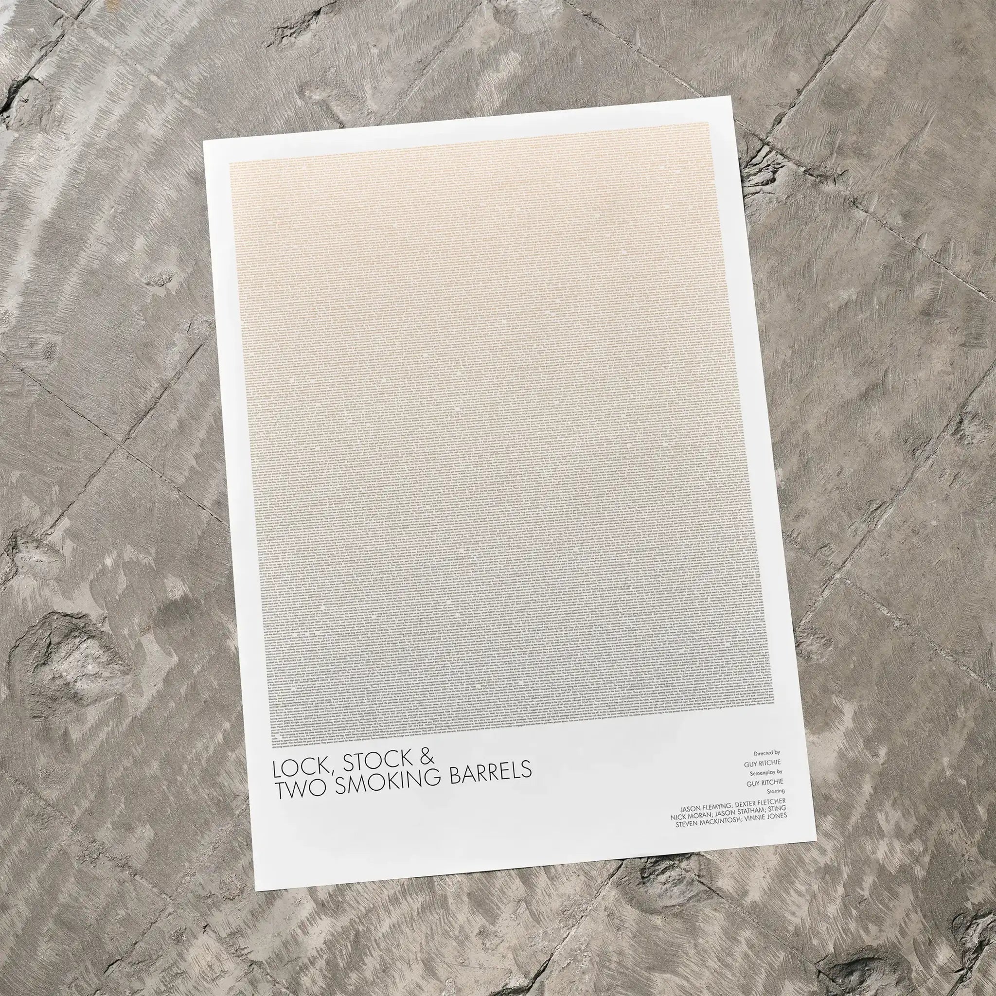 A Lock, Stock and Two Smoking Barrels movie script poster laid flat on a textured floor surface.