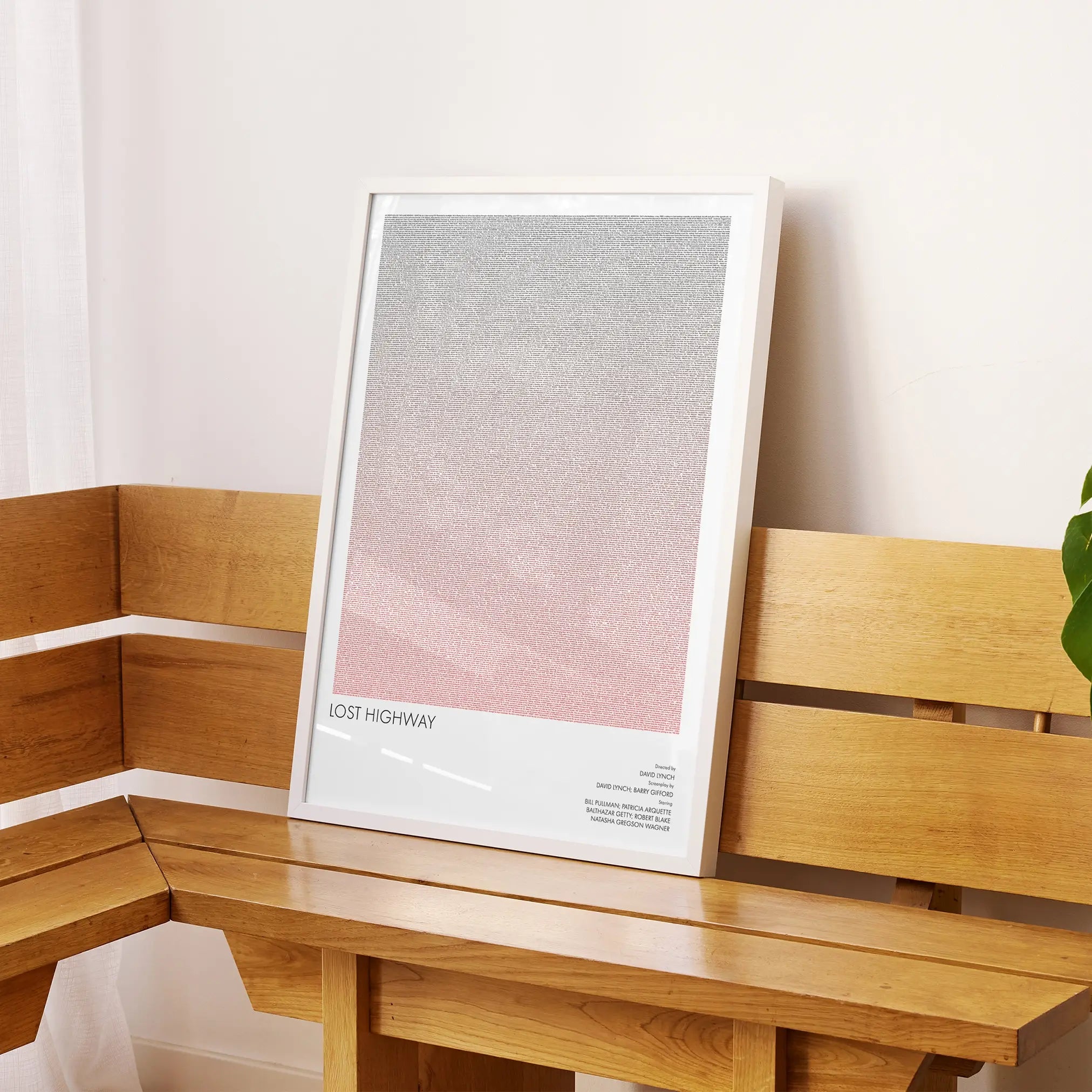 A framed Lost Highway movie script poster displayed on a sideboard in a contemporary space.