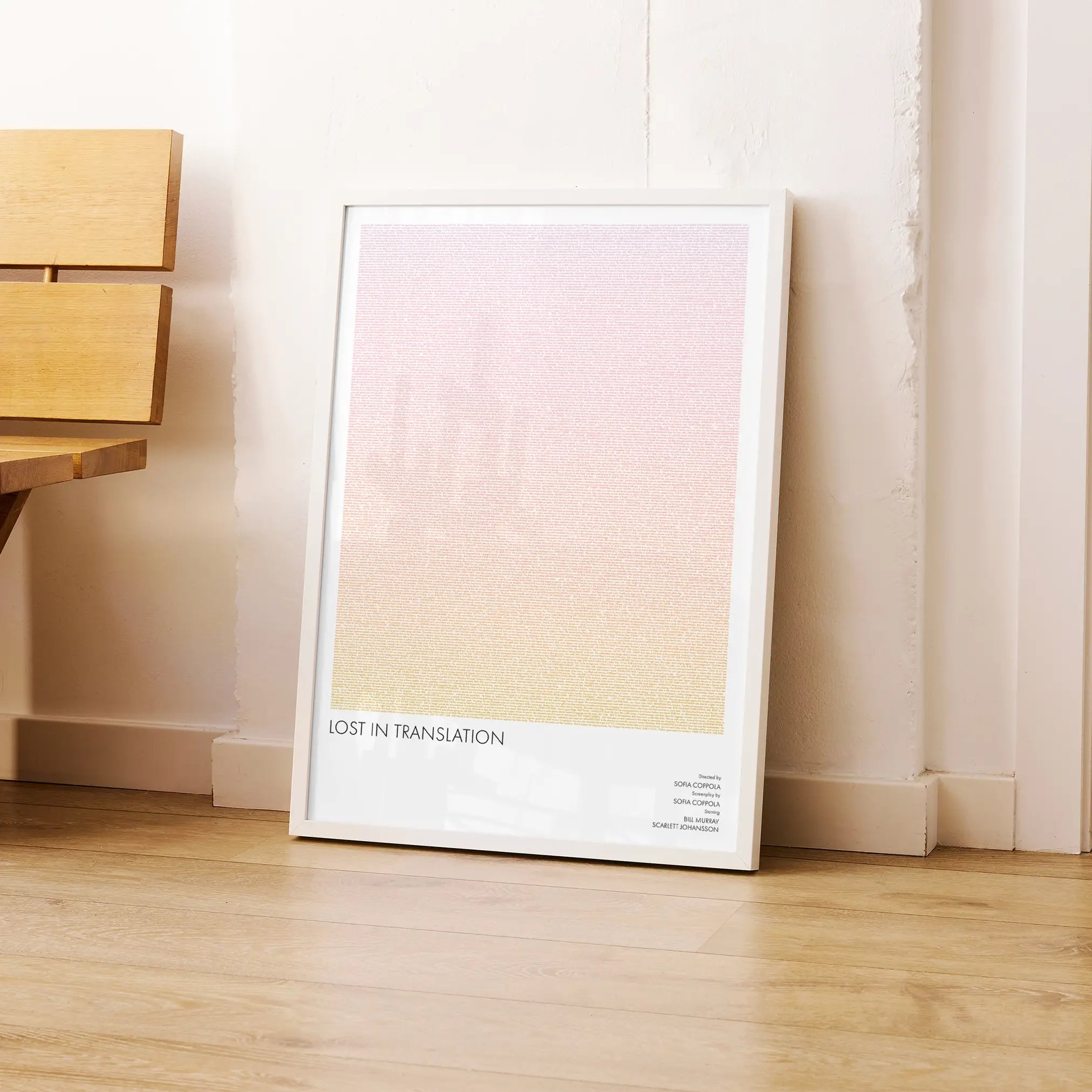 A framed Lost in Translation movie script poster leaning against a wall in a modern interior.