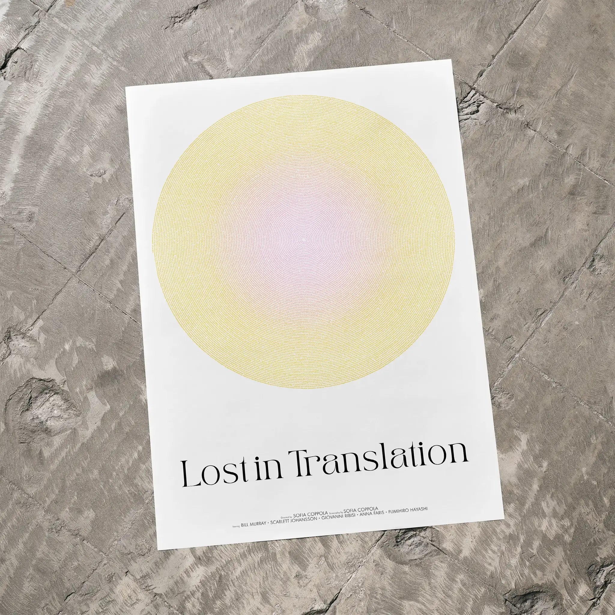 Poster with a yellow circle and 'Lost in Translation' text on a textured gray surface