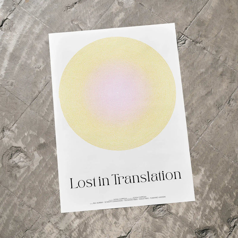 Poster with a yellow circle and 'Lost in Translation' text on a textured gray surface