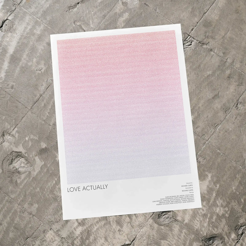 A Love Actually movie script poster laid flat on a textured floor surface.