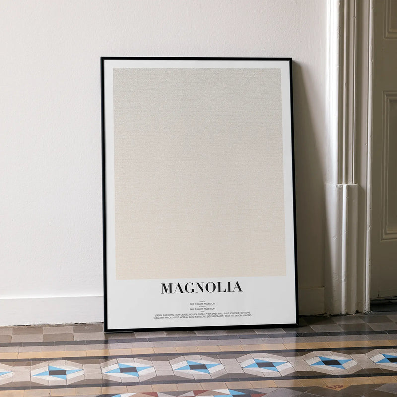 A framed Magnolia movie script poster leaning against a wall in a minimalist interior.