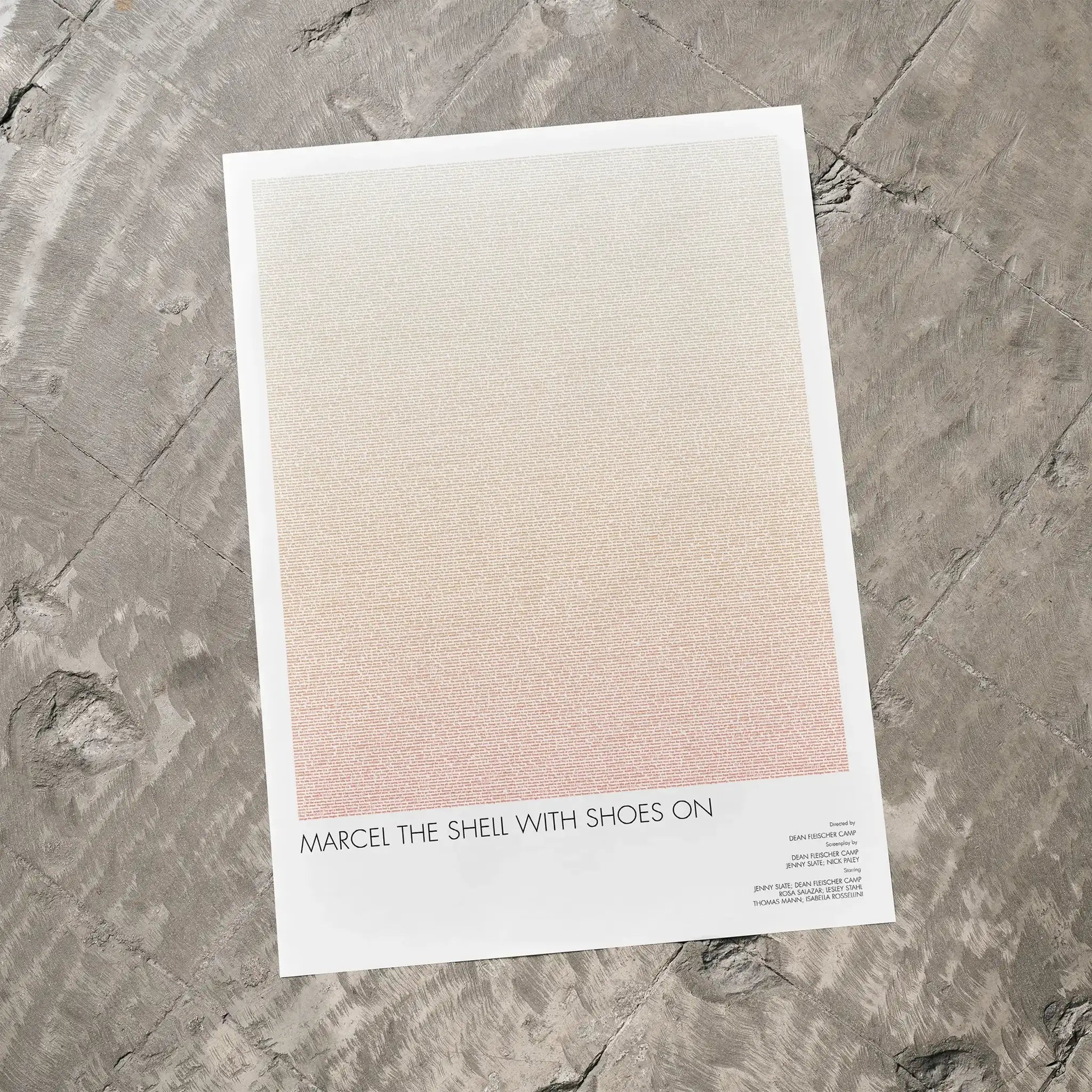 A Marcel the Shell with Shoes On movie script poster laid flat on a textured floor surface.