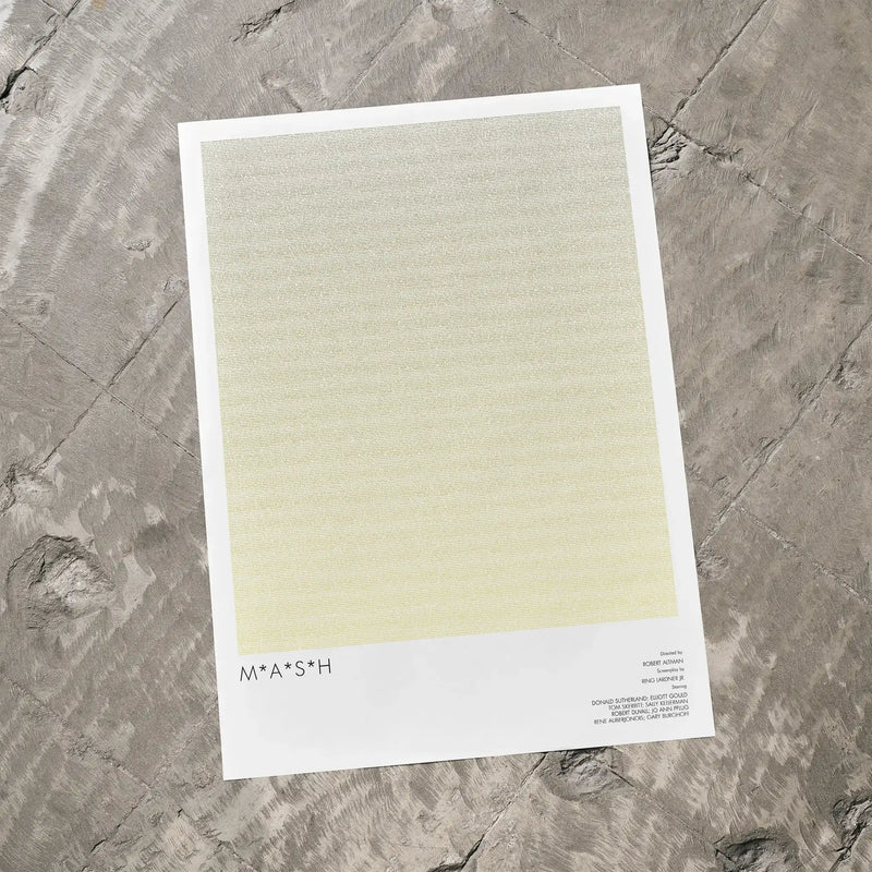 A M*A*S*H movie script poster laid flat on a textured floor surface.