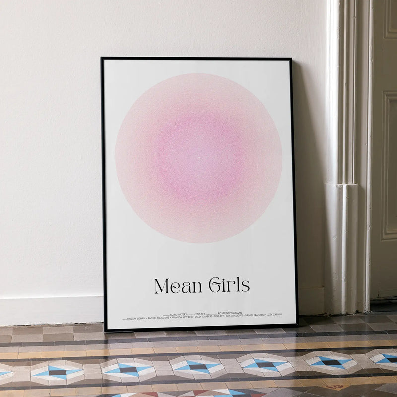 Framed Mean Girls script movie poster leaning on white wall.