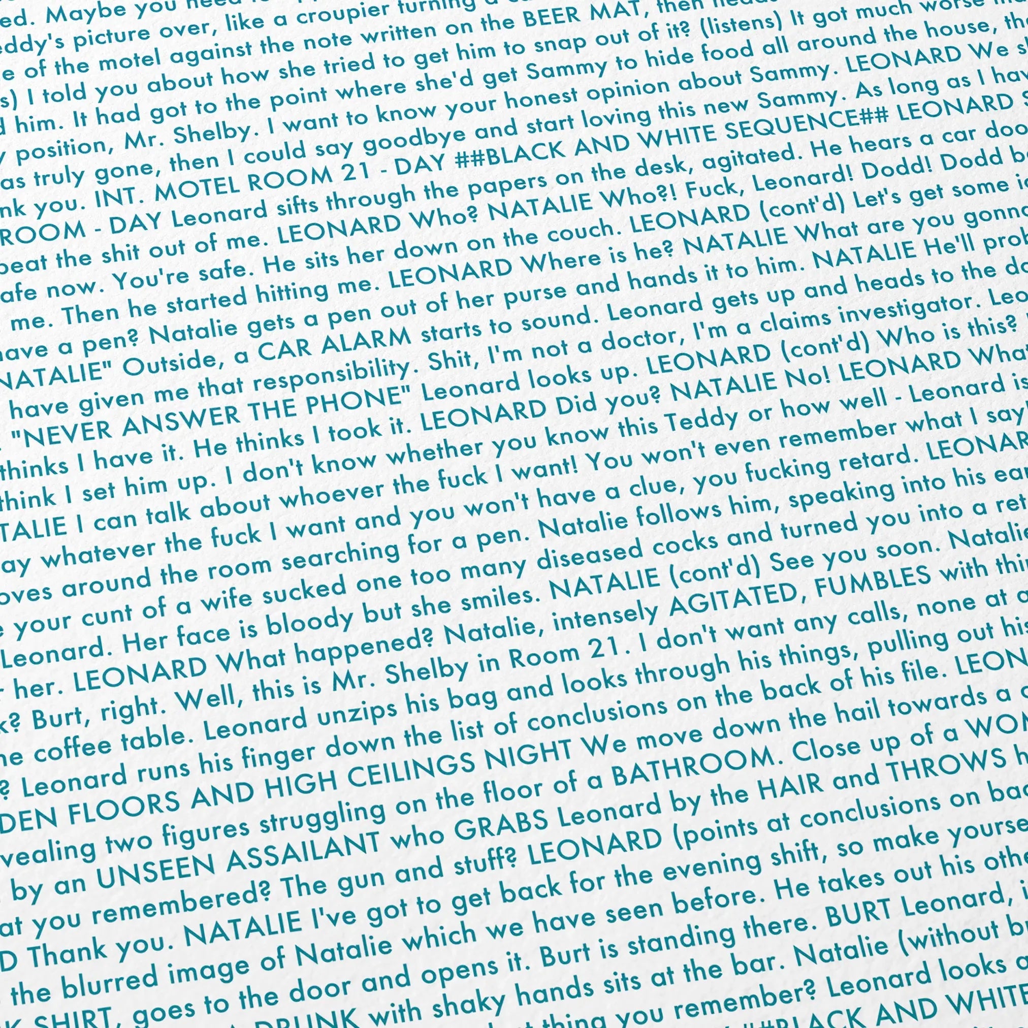 Close-up detail of the Memento movie script poster showing dense typographic text.