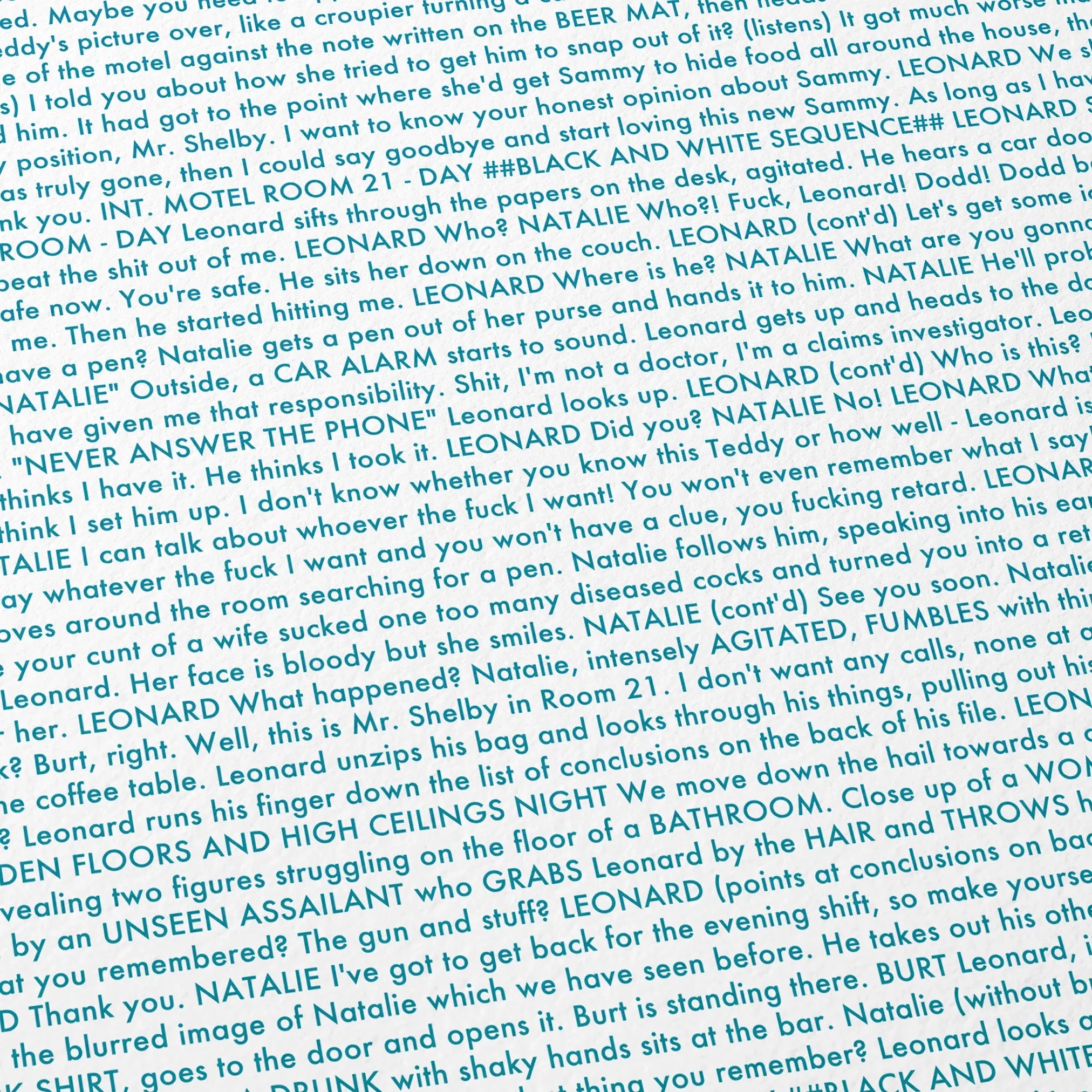Close-up detail of the Memento movie script poster showing dense typographic text.