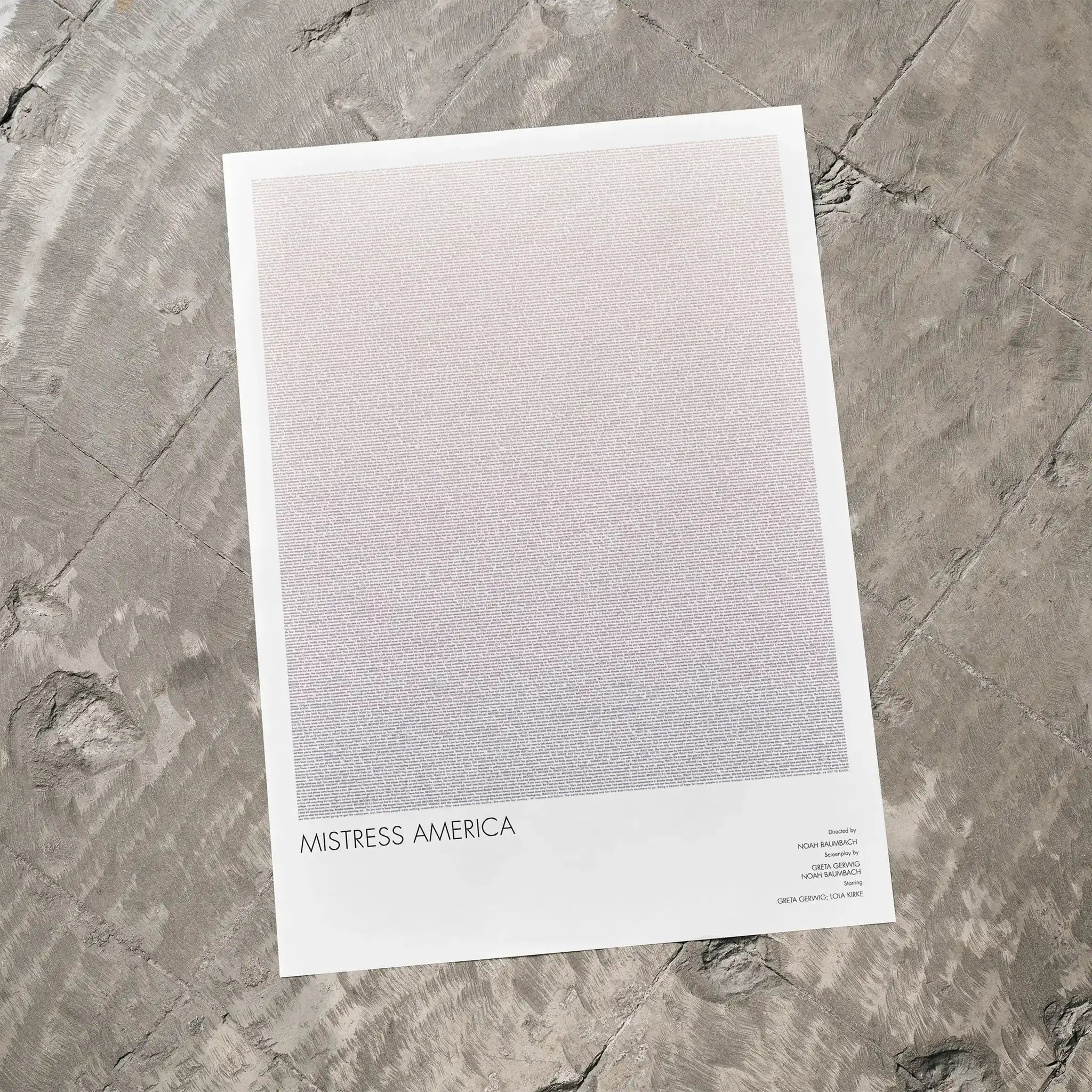 A Mistress America movie script poster laid flat on a textured floor surface.