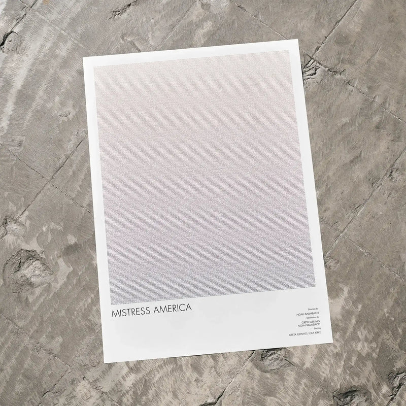 A Mistress America movie script poster laid flat on a textured floor surface.