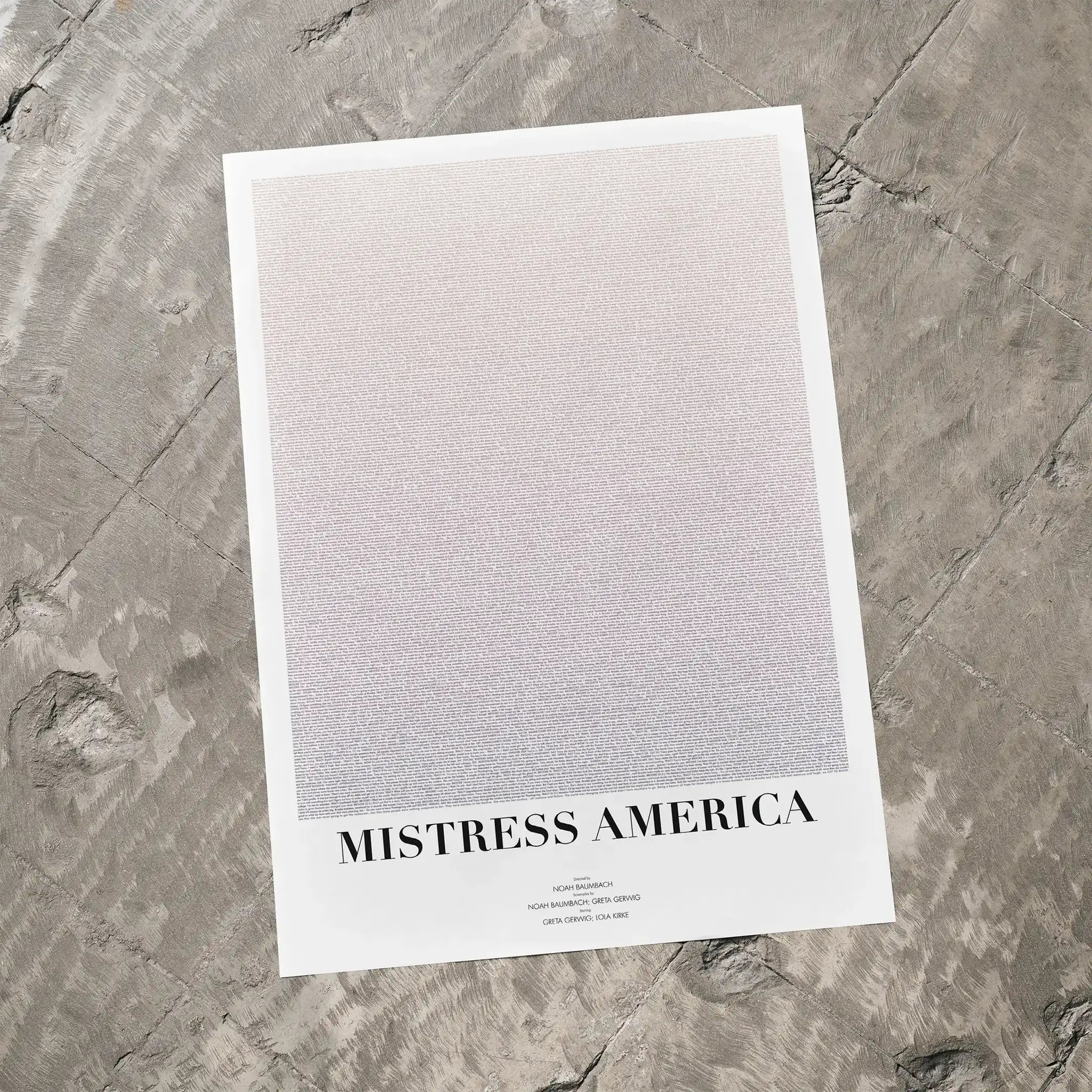 A Mistress America movie script poster laid flat on a textured floor surface.