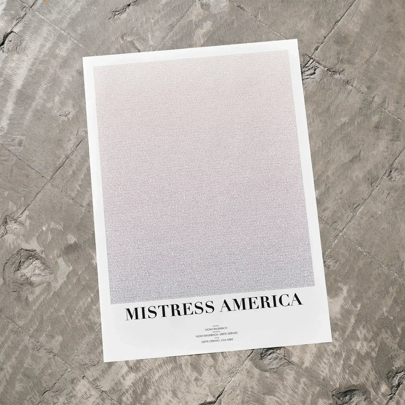 A Mistress America movie script poster laid flat on a textured floor surface.