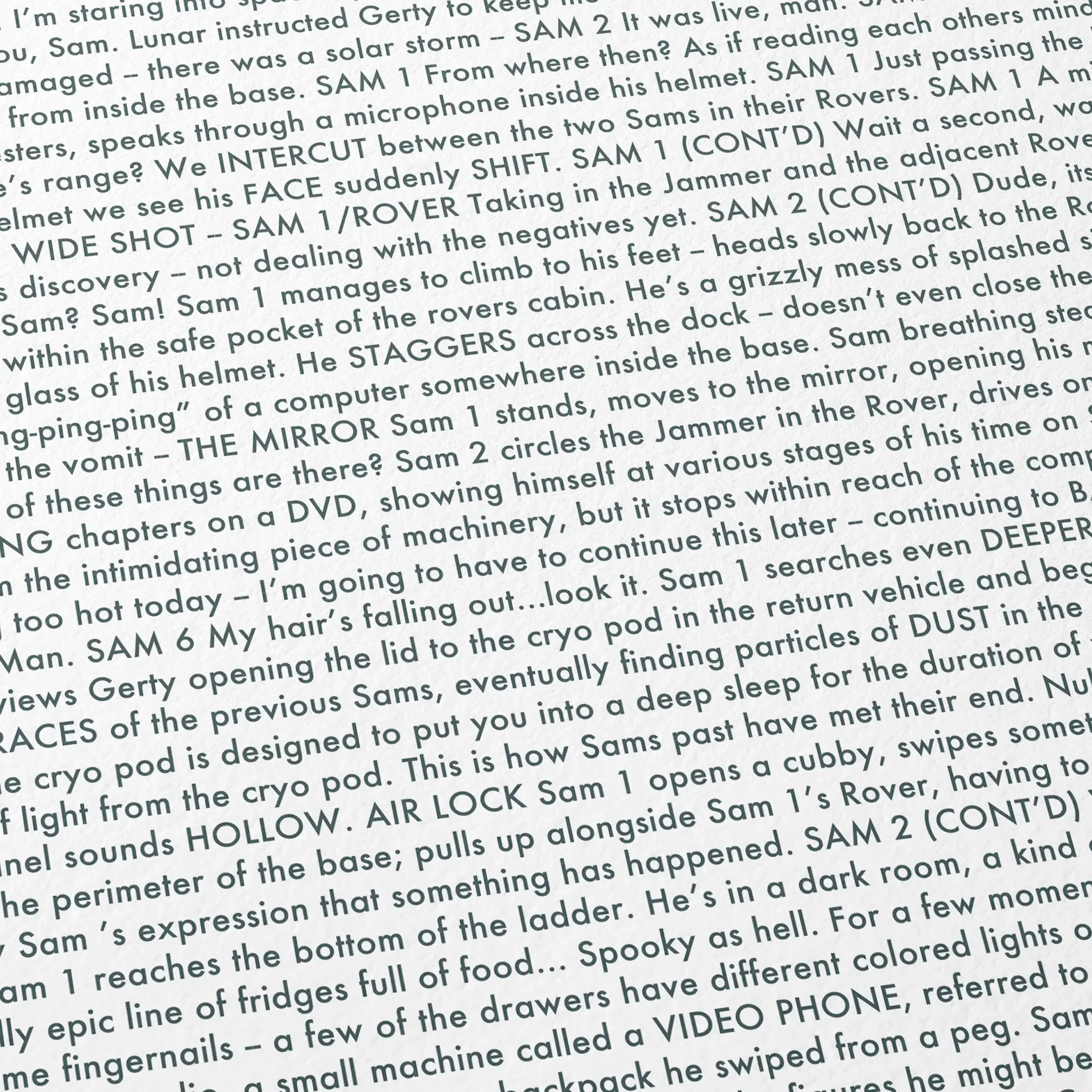 Close-up detail of the Moon movie script poster showing dense typographic text.