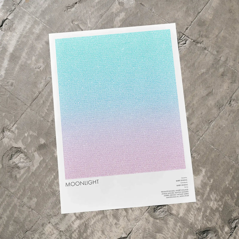 A Moonlight movie script poster laid flat on a textured floor surface.