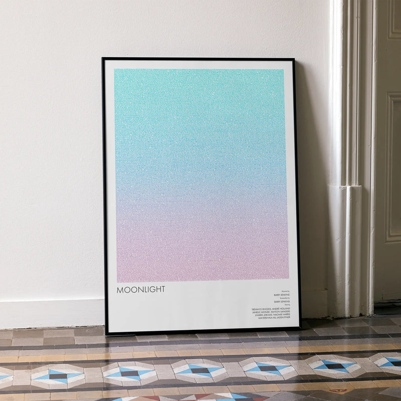 A framed Moonlight movie script poster leaning against a wall in a minimalist interior.