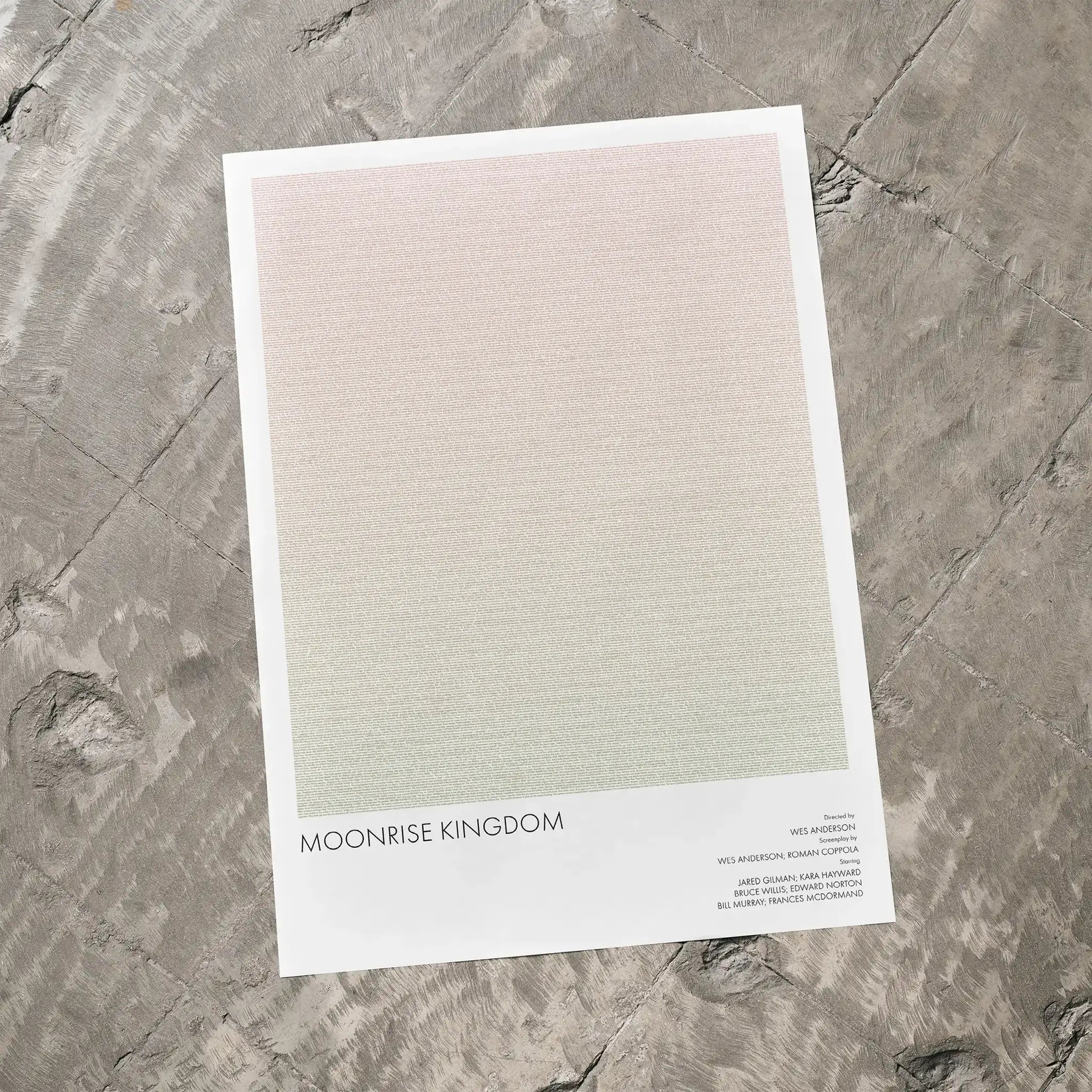 A Moonrise Kingdom movie script poster laid flat on a textured floor surface.