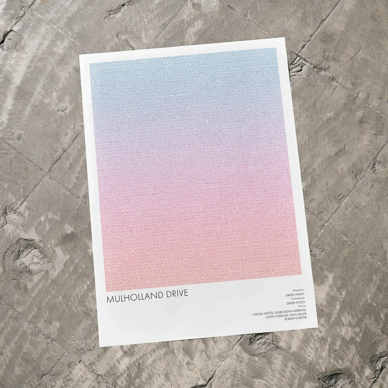 A Mulholland Drive movie script poster laid flat on a textured floor surface.