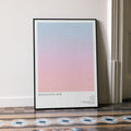 A framed Mulholland Drive movie script poster leaning against a wall in a minimalist interior.