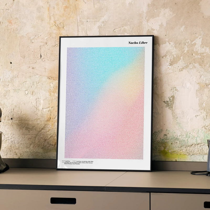 A framed Nacho Libre movie script poster displayed on a cabinet in a minimalist interior.
