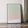 A framed National Lampoon's Christmas Vacation movie script poster leaning against a wall in a minimalist interior.